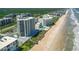 Beautiful aerial view of a beachfront condo community, swimming pools, and direct beach access at 5207 S Atlantic Ave # 723, New Smyrna Beach, FL 32169