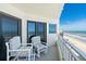 Balcony featuring chairs and sliding doors with ocean views, offering a relaxing outdoor space at 5207 S Atlantic Ave # 723, New Smyrna Beach, FL 32169