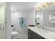 Bright bathroom featuring a vanity with a marble countertop and a modern glass-enclosed shower at 5207 S Atlantic Ave # 723, New Smyrna Beach, FL 32169