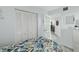 Bedroom showcasing closet space and access to a beautifully decorated living area, providing a seamless flow at 5207 S Atlantic Ave # 723, New Smyrna Beach, FL 32169