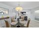 Elegant dining area with stylish chandelier, adjacent to kitchen and living spaces at 5207 S Atlantic Ave # 723, New Smyrna Beach, FL 32169