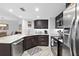 Well-appointed kitchen boasts dark wood cabinetry, stainless steel appliances, and marble countertops at 5207 S Atlantic Ave # 723, New Smyrna Beach, FL 32169