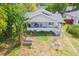 Aerial view of a home with a quaint front porch and lush greenery surrounding the property at 5261 3Rd St, Orlando, FL 32810