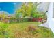 Spacious backyard featuring a mix of open space, trees, and lush greenery and a small patio area at 5261 3Rd St, Orlando, FL 32810