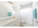Updated bathroom features a shower with tile surround, modern vanity, and a large mirror at 5261 3Rd St, Orlando, FL 32810