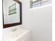 Bathroom featuring a sink, mirror, and a bright window at 5261 3Rd St, Orlando, FL 32810