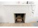 Close-up of a traditional white brick fireplace with a classic mantel and hearth at 5261 3Rd St, Orlando, FL 32810