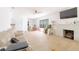 Bright living room with a brick fireplace, ceiling fan, wood-look floors, and a comfortable seating area at 5261 3Rd St, Orlando, FL 32810