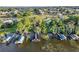 Aerial view of waterfront homes with private docks and boat lifts, surrounded by lush landscaping at 5305 Indian Ocean Loop, Tavares, FL 32778