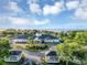 Aerial view of a community building with manicured landscaping, gazebos, and waterfront views at 5305 Indian Ocean Loop, Tavares, FL 32778