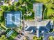 Aerial view features tennis courts, outdoor pool, and the community recreation center at 5305 Indian Ocean Loop, Tavares, FL 32778