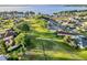 Breathtaking aerial view of the community featuring lush green spaces, walking paths, and stunning waterfront homes at 5305 Indian Ocean Loop, Tavares, FL 32778