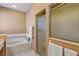 Bright bathroom featuring a soaking tub, stand up shower, and a frosted window at 5305 Indian Ocean Loop, Tavares, FL 32778