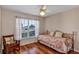 Charming bedroom with hardwood floors, a daybed, and a sunlit window at 5305 Indian Ocean Loop, Tavares, FL 32778