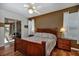 Comfortable bedroom with hardwood floors, ceiling fan, and glass sliding doors to an outdoor living space at 5305 Indian Ocean Loop, Tavares, FL 32778