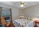 Bedroom with wood-look floors, a comfortable bed, large window, and reading chair at 5305 Indian Ocean Loop, Tavares, FL 32778