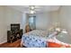 Comfortable bedroom featuring wood-look flooring, a ceiling fan, and a traditional dresser at 5305 Indian Ocean Loop, Tavares, FL 32778