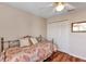 Cozy bedroom featuring a decorative metal frame bed, ceiling fan, and wood-look flooring at 5305 Indian Ocean Loop, Tavares, FL 32778