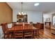 Traditional dining room featuring hardwood floors, a decorative light fixture, and wood furniture at 5305 Indian Ocean Loop, Tavares, FL 32778