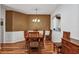 Traditional dining room featuring hardwood floors, a decorative light fixture, and wood furniture at 5305 Indian Ocean Loop, Tavares, FL 32778