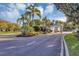 Entrance to the community features lush landscaping and a gate house with mature palm trees at 5305 Indian Ocean Loop, Tavares, FL 32778