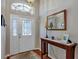Elegant foyer with decorative mirror and console table with lamps at 5305 Indian Ocean Loop, Tavares, FL 32778
