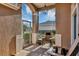 Cozy screened front porch with a chair, perfect for relaxing outdoors at 5305 Indian Ocean Loop, Tavares, FL 32778