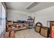 Attached garage with a pegboard on the wall, workbench, and storage shelves at 5305 Indian Ocean Loop, Tavares, FL 32778