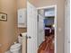 Hallway leading to a bedroom with wood floors and closet doors at 5305 Indian Ocean Loop, Tavares, FL 32778