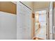 Hallway with hardwood floors leading to a bathroom featuring a vanity, bathtub, and toilet at 5305 Indian Ocean Loop, Tavares, FL 32778