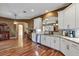 Open-concept kitchen with granite counters and white cabinets at 5305 Indian Ocean Loop, Tavares, FL 32778