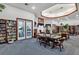 Cozy community library with bookshelves, comfortable seating, and a pool view for relaxing reading at 5305 Indian Ocean Loop, Tavares, FL 32778