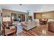 Open-concept living room with wood floors and view of screened patio at 5305 Indian Ocean Loop, Tavares, FL 32778