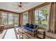 Inviting sunroom featuring large windows, comfortable seating, and wood-look flooring at 5305 Indian Ocean Loop, Tavares, FL 32778