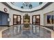 Elegant community lobby with marble floors, decorative planters, and library access through wood-framed glass doors at 5305 Indian Ocean Loop, Tavares, FL 32778