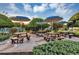 Outdoor picnic area with multiple picnic tables covered by shade umbrellas at 5305 Indian Ocean Loop, Tavares, FL 32778