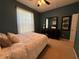 Bedroom with green accent walls, carpet flooring and a large window at 5548 Burlwood Dr, Orlando, FL 32810