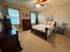 Serene bedroom with a comfortable bed, warm neutral paint, and a ceiling fan at 5548 Burlwood Dr, Orlando, FL 32810