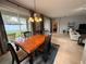 Cozy dining area with a wooden table, chairs, and sliding glass doors to the backyard at 5548 Burlwood Dr, Orlando, FL 32810