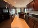 Galley kitchen featuring granite countertops, black appliances and warm cabinetry at 5548 Burlwood Dr, Orlando, FL 32810