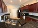 Close-up of kitchen with granite countertops, stainless steel sink, and dark wooden cabinets at 5548 Burlwood Dr, Orlando, FL 32810