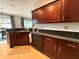 Well-equipped kitchen showcasing granite counters, black appliances, and dark wooden cabinets at 5548 Burlwood Dr, Orlando, FL 32810