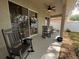 Covered patio with ceiling fan and comfortable rocking chairs at 5548 Burlwood Dr, Orlando, FL 32810