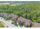 Aerial view of a residential area showcasing townhomes surrounded by greenery and trees at 6078 Tivoli Gardens Blvd, Orlando, FL 32829