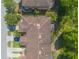 Aerial view showcasing a community of residences with well-maintained roofs and green surroundings at 6078 Tivoli Gardens Blvd, Orlando, FL 32829