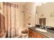 Bathroom featuring a vanity with dark countertop, a shower with leaf-patterned curtains, and neutral walls at 6078 Tivoli Gardens Blvd, Orlando, FL 32829
