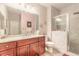 Bathroom featuring a white marble shower, cherry wood vanity with a white countertop, and modern fixtures at 6078 Tivoli Gardens Blvd, Orlando, FL 32829