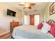 Bedroom displaying a full bed, a sliding wood door to the right, and a mounted TV at 6078 Tivoli Gardens Blvd, Orlando, FL 32829