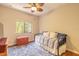 Cozy bedroom features a stylish daybed, a colorful rug, and plenty of natural light from a window at 6078 Tivoli Gardens Blvd, Orlando, FL 32829