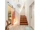 Bright foyer with wooden stairs, barn door leading to the powder room, and natural light at 6078 Tivoli Gardens Blvd, Orlando, FL 32829